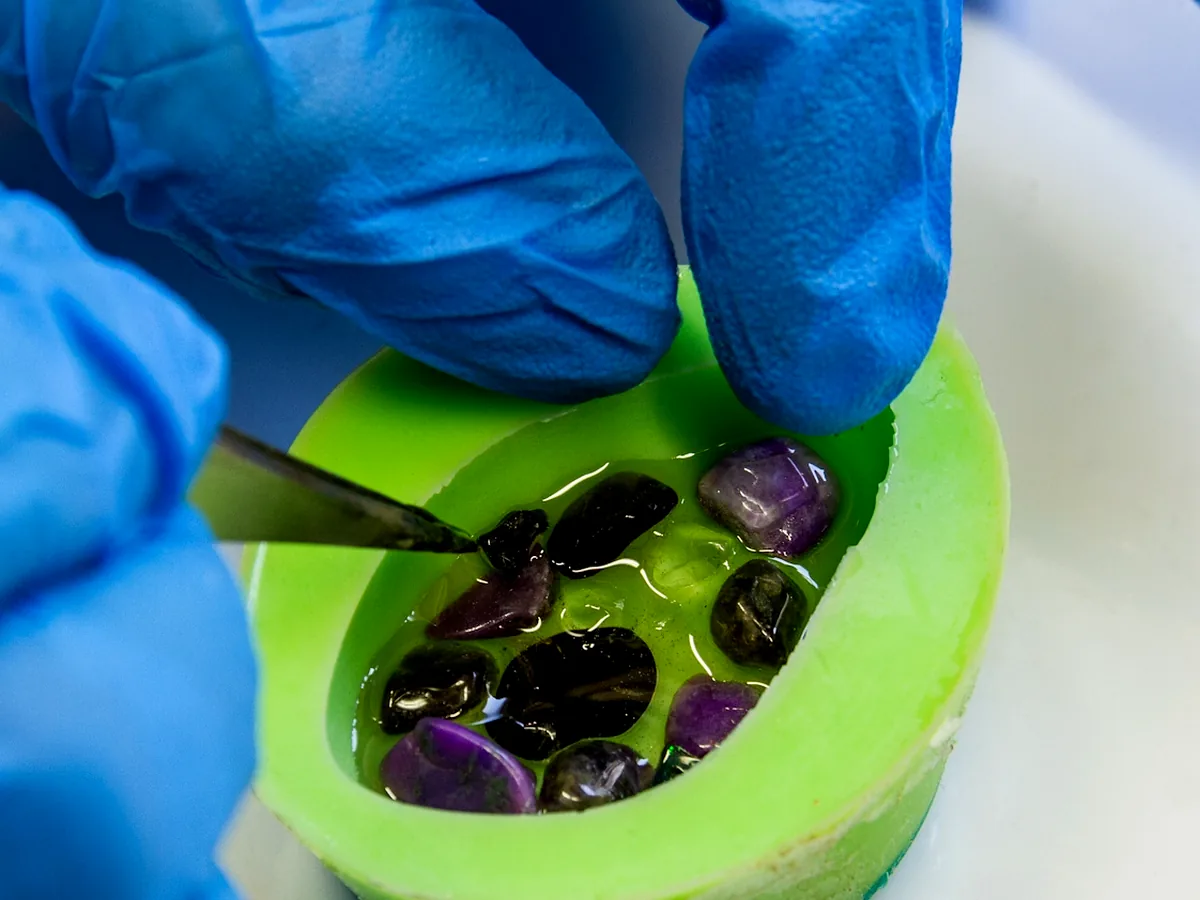 Gemstones placed by hand into the mould – OZ Orgonite workshop